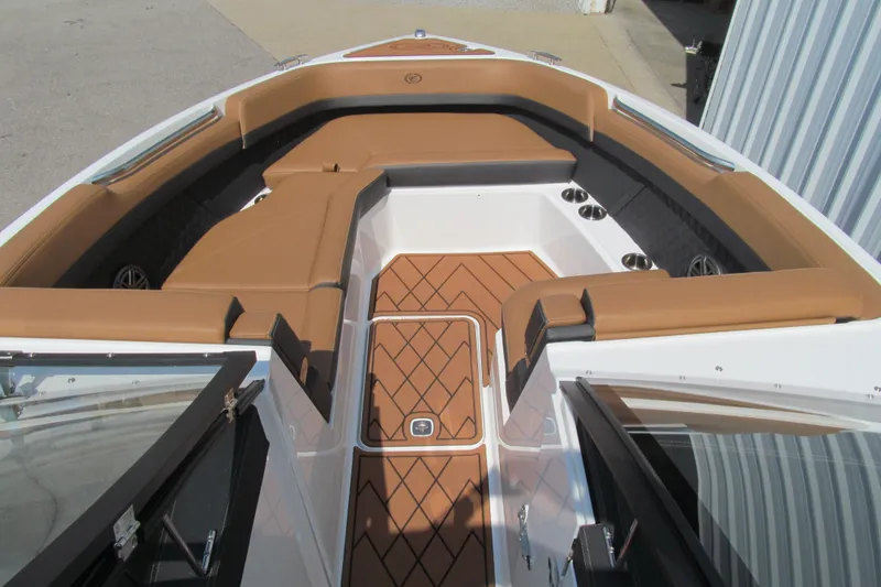 Slide: The Image of 2026 Cobalt R8 boat interior with tan seating and wood-patterned flooring. - 14