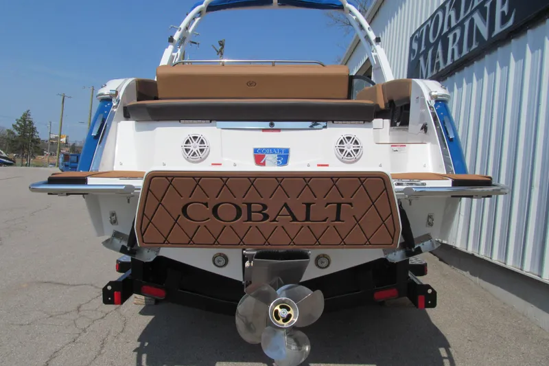 Slide: The Image of Rear view of 2026 Cobalt R8 boat with brown deck and propeller. - 6