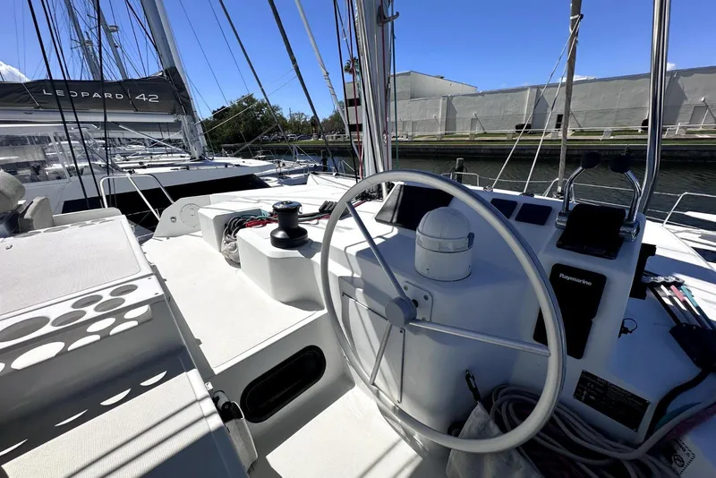 Slide: The Image of 2023 Bali CATSPACE yacht cockpit with steering wheel and navigation equipment. - 13