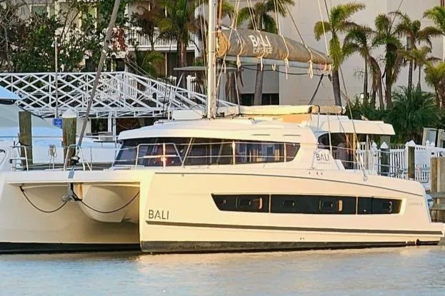 Slide: The Image of 2023 Bali CATSPACE catamaran docked by palm trees, showcasing sleek design and modern features. - 3