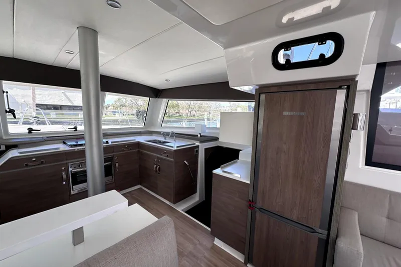 Slide: The Image of Modern kitchen interior of 2023 Bali CATSPACE catamaran with sleek wood cabinetry and appliances. - 30