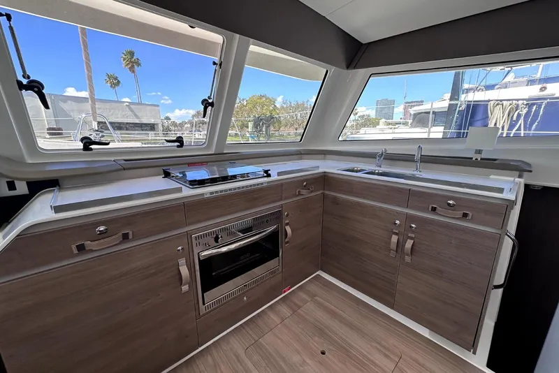 Slide: The Image of Modern kitchen interior of 2023 Bali CATSPACE yacht with wood cabinetry and large windows. - 31