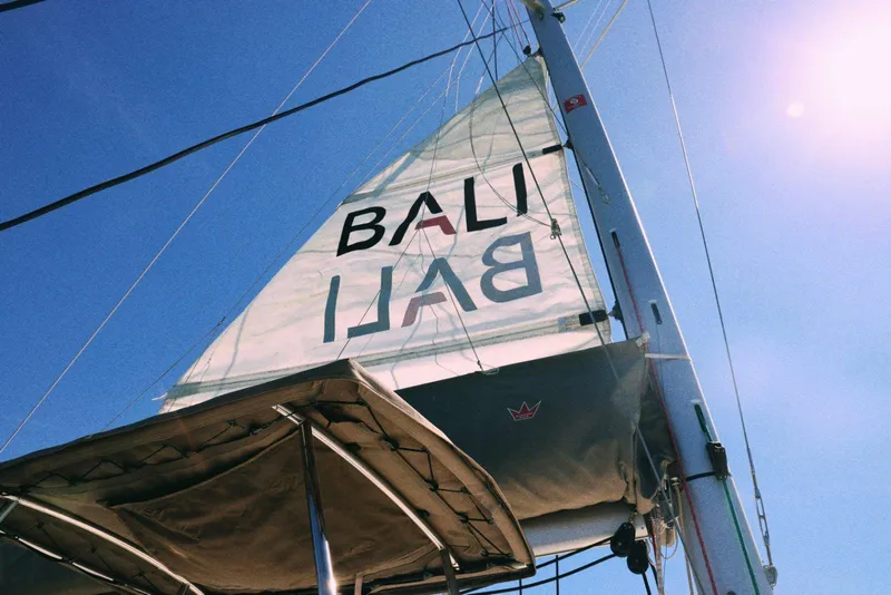 Slide: The Image of Sail of 2023 Bali CATSPACE catamaran against clear blue sky. - 4
