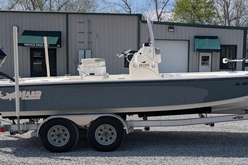 The Image of 2021 Mako 21 LTS boat on trailer, parked outside a service building. - 0