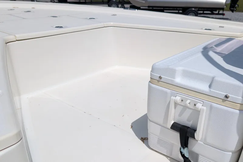 Slide: The Image of 2021 Mako 21 LTS boat deck with cooler, showcasing spacious storage area. - 11