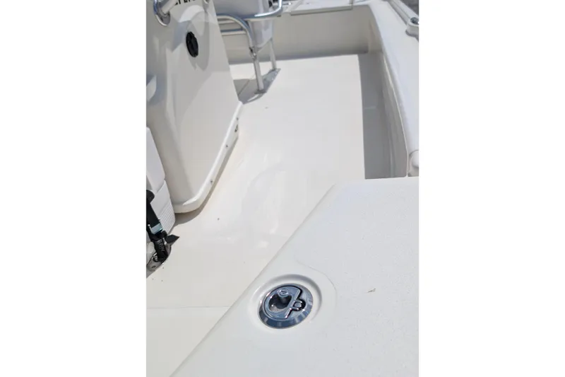 Slide: The Image of 2021 Mako 21 LTS boat interior, showcasing sleek white deck and seating area. - 12