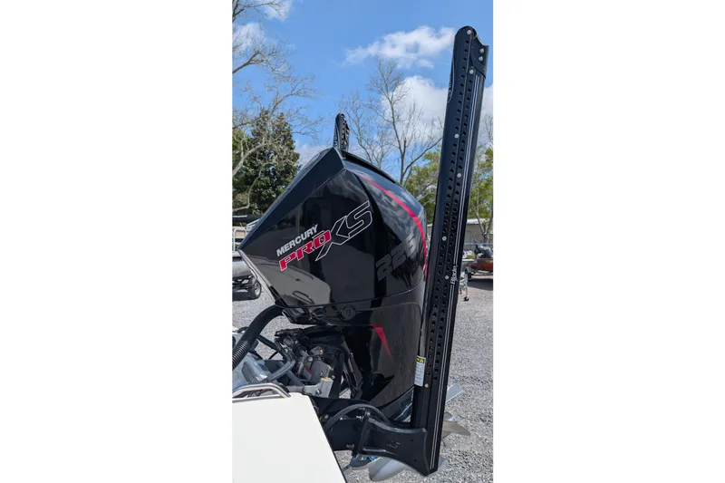 Slide: The Image of Mercury Pro XS outboard motor on 2021 Mako 21 LTS boat, parked outdoors. - 4