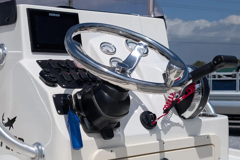 Slide: The Image of Steering console of a 2021 Mako 21 LTS boat with modern controls and gauges. - 5