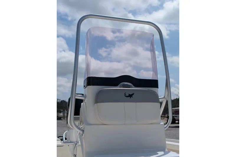 Slide: The Image of 2021 Mako 21 LTS boat console with windshield under a cloudy sky. - 6
