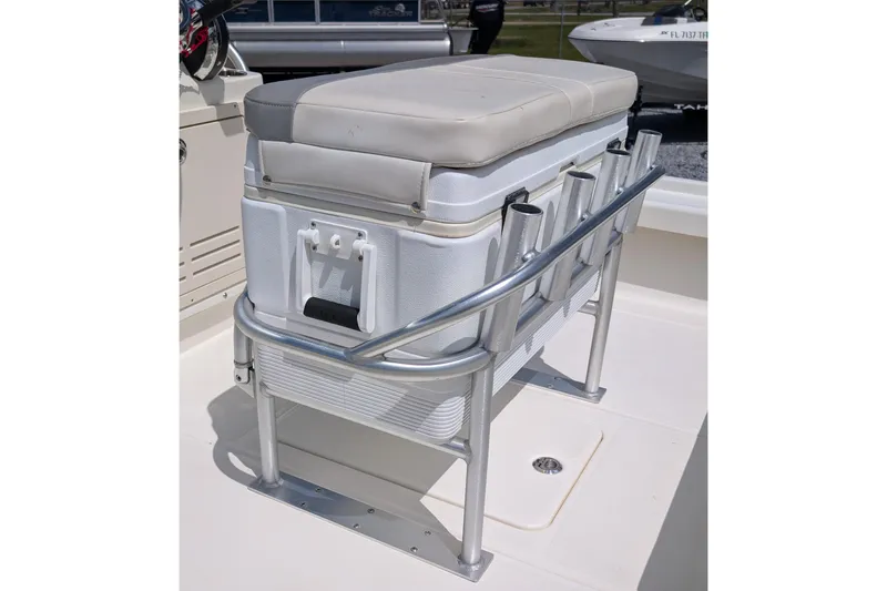 Slide: The Image of 2021 Mako 21 LTS boat with cushioned cooler seat and rod holders. - 7
