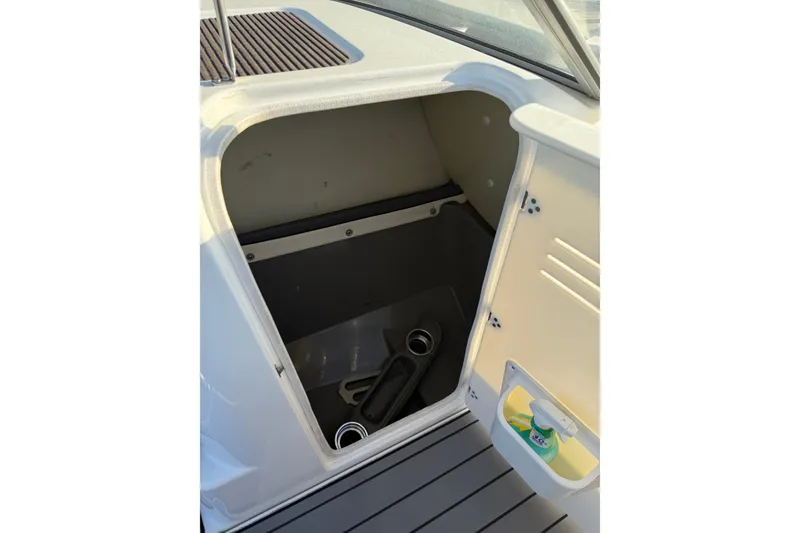 Slide: The Image of Storage compartment on a 2011 Yamaha Boats 242 Limited S, open with visible interior. - 11