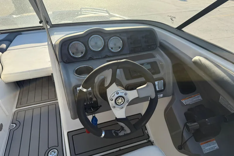 Slide: The Image of Steering console of 2011 Yamaha Boats 242 Limited S with gauges and controls. - 9