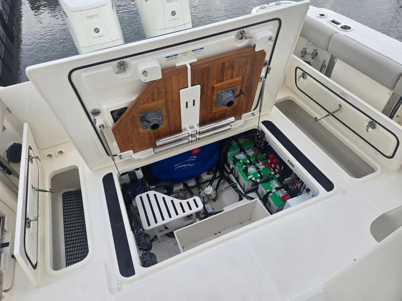 Slide: The Image of Boston Whaler 365 Conquest 2026 engine compartment with batteries and equipment. - 13