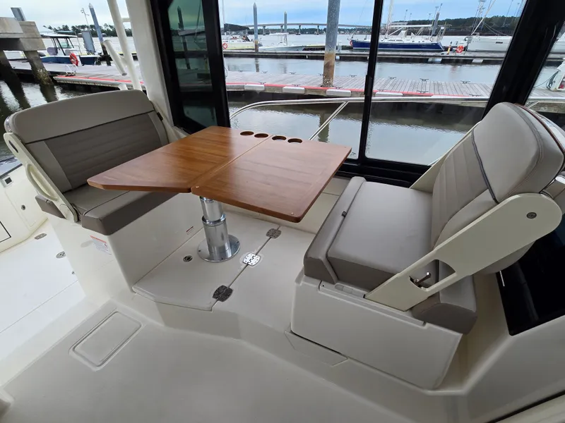 Slide: The Image of Interior of 2026 Boston Whaler 365 Conquest with table and seating. - 23