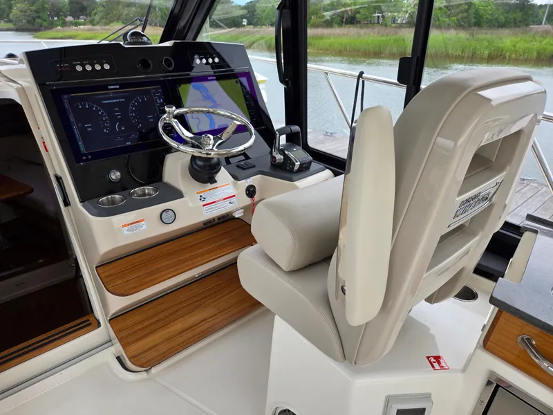 Slide: The Image of Interior of 2026 Boston Whaler 365 Conquest with modern helm console. - 28