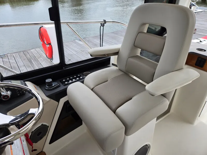 Slide: The Image of Interior of 2026 Boston Whaler 365 Conquest with captain's chair. - 30