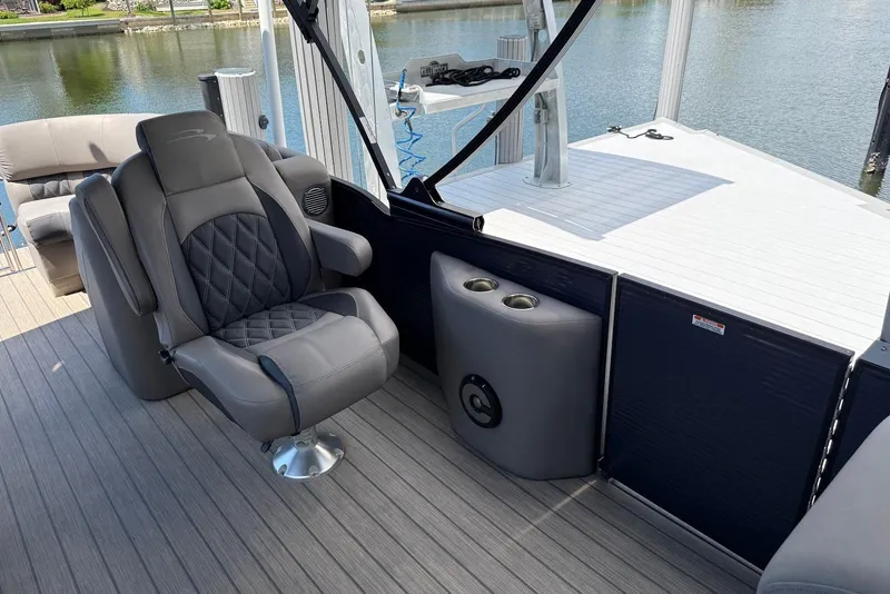 Slide: The Image of Luxurious seating on 2019 Bennington R 23 RSFB pontoon boat, featuring elegant design and cup holders. - 11
