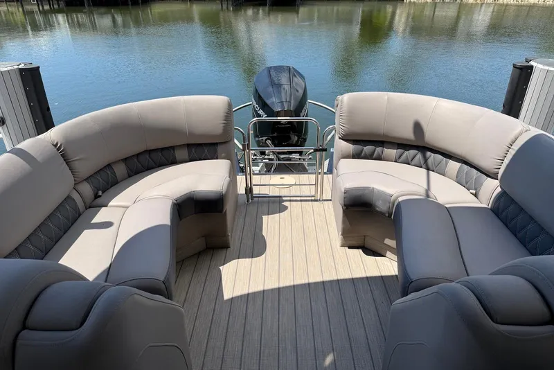 Slide: The Image of 2019 Bennington R 23 RSFB pontoon boat with luxurious seating on a serene lake. - 12