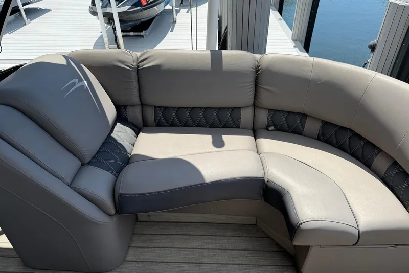 Slide: The Image of Luxurious seating on a 2019 Bennington R 23 RSFB pontoon boat, docked by the water. - 13