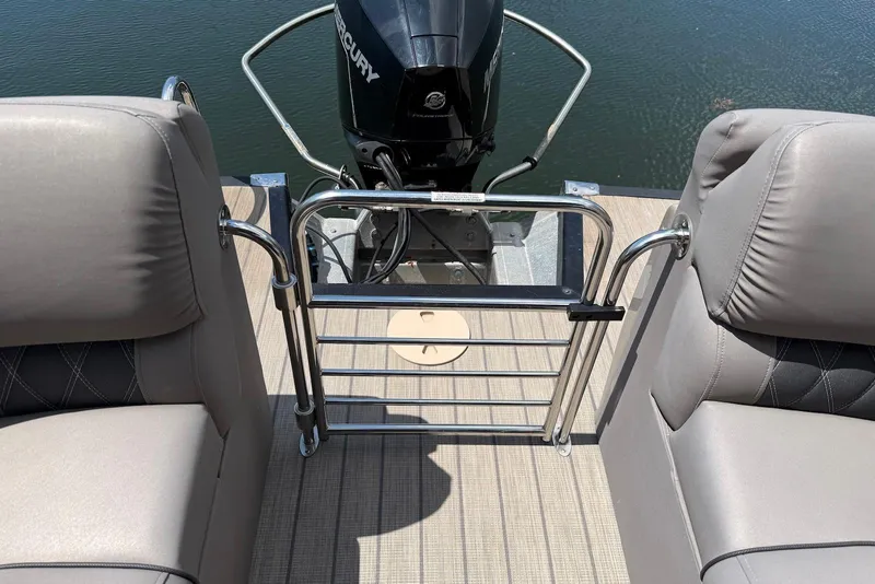 Slide: The Image of 2019 Bennington R 23 RSFB boat interior with Mercury engine, featuring comfortable seating and railing. - 15