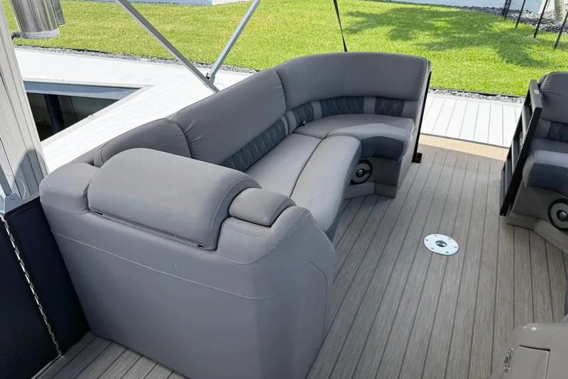 Slide: The Image of 2019 Bennington R 23 RSFB boat interior with gray seating and wooden deck. - 6