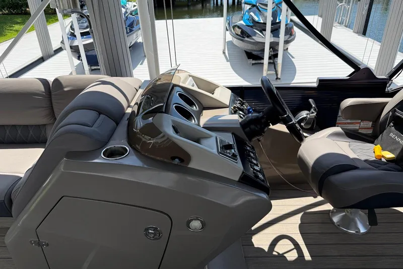 Slide: The Image of 2019 Bennington R 23 RSFB boat interior with steering wheel and seating area. - 8