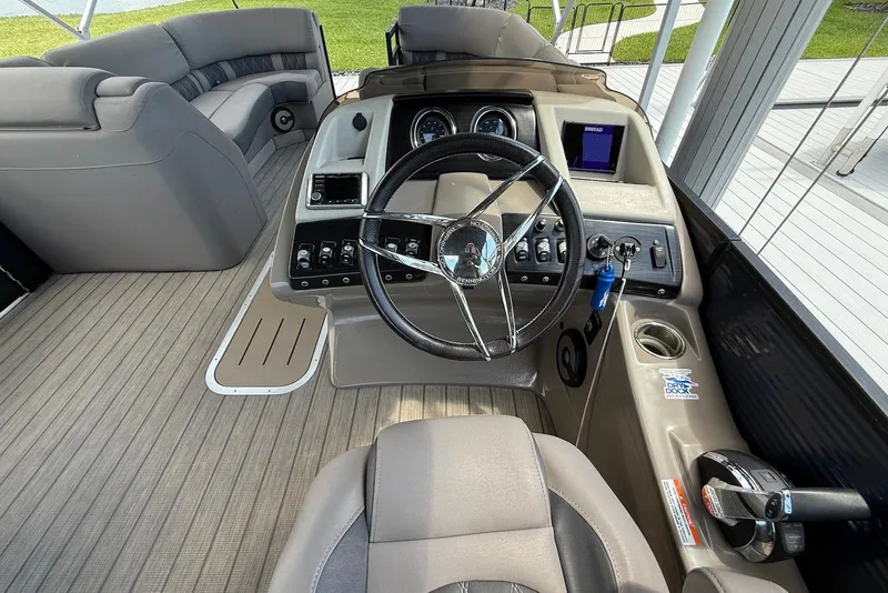 Slide: The Image of 2019 Bennington R 23 RSFB boat cockpit with steering wheel and control panel. - 9