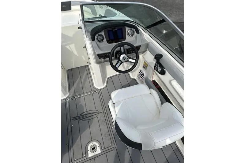 Slide: The Image of 2023 Chaparral 21 SSi boat interior with steering wheel and dashboard. - 13