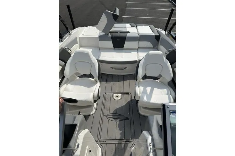 Slide: The Image of 2023 Chaparral 21 SSi boat interior with white seating and gray flooring. - 14