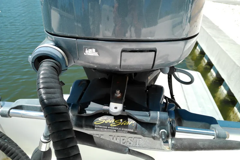 Slide: The Image of Outboard motor on a 2009 Key West 2020 Walkaround boat, featuring SeaStar hydraulic steering. - 11