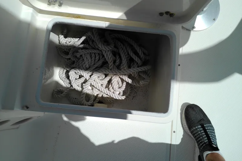 Slide: The Image of Storage compartment with coiled rope on a 2009 Key West 2020 Walkaround boat. - 13