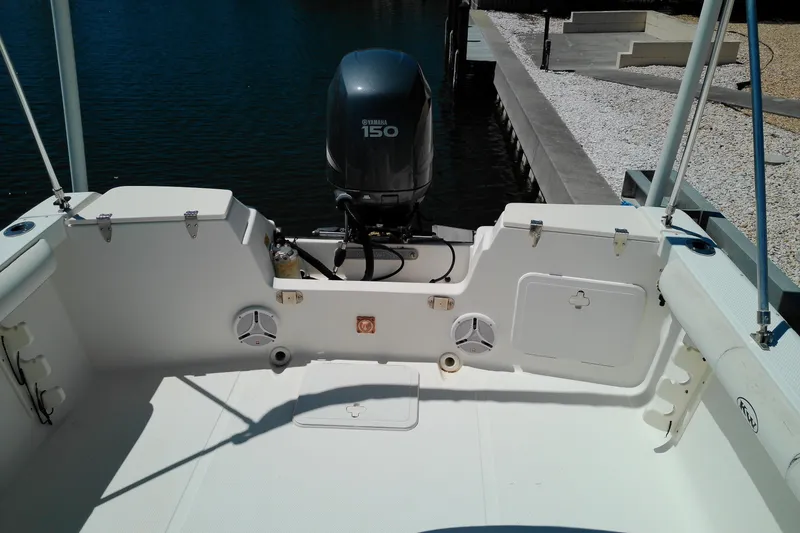 Slide: The Image of Key West 2020 Walkaround boat with Yamaha 150 engine, docked by the water. - 18