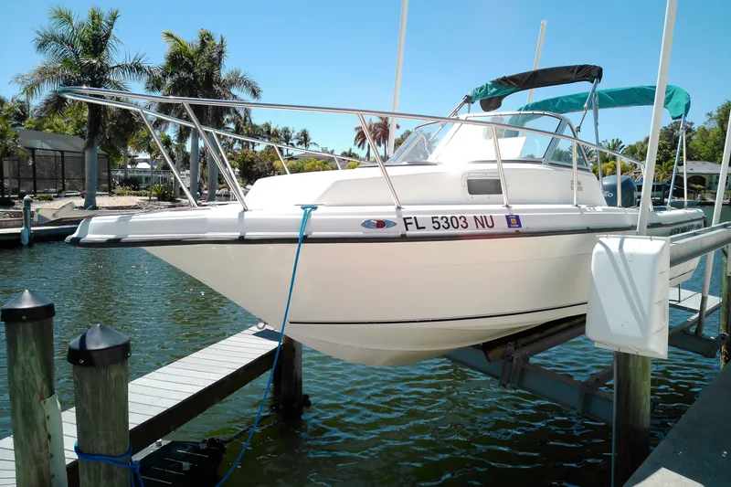 Slide: The Image of Key West 2020 Walkaround boat docked, surrounded by palm trees and clear blue sky. - 2
