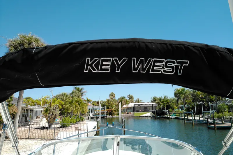 Slide: The Image of Key West 2020 Walkaround boat with scenic waterfront view, palm trees, and clear blue sky. - 20