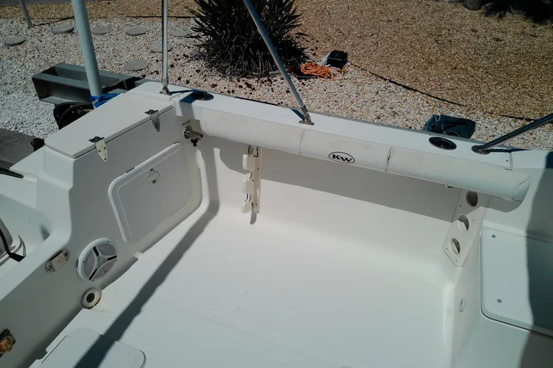 Slide: The Image of Key West 2020 Walkaround boat interior, featuring storage compartments and rod holders. - 22