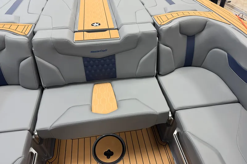 Slide: The Image of 2026 MasterCraft XT22 boat interior with gray and tan seating, featuring stylish design elements. - 10