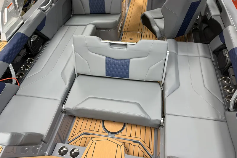 Slide: The Image of 2026 MasterCraft XT22 boat interior with luxurious gray seating and wood accents. - 12