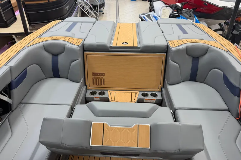 Slide: The Image of 2026 MasterCraft XT22 boat interior with sleek gray and wood-accented seating. - 13