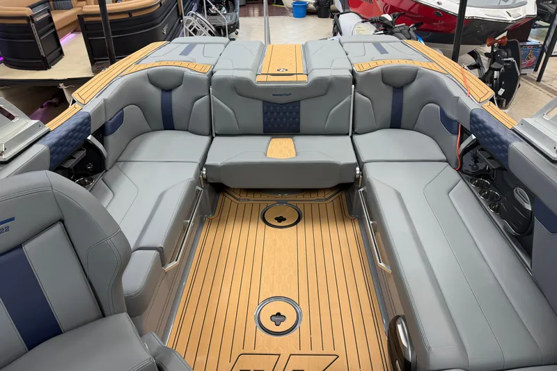 Slide: The Image of 2026 MasterCraft XT22 boat interior with luxurious gray seating and teak flooring. - 4
