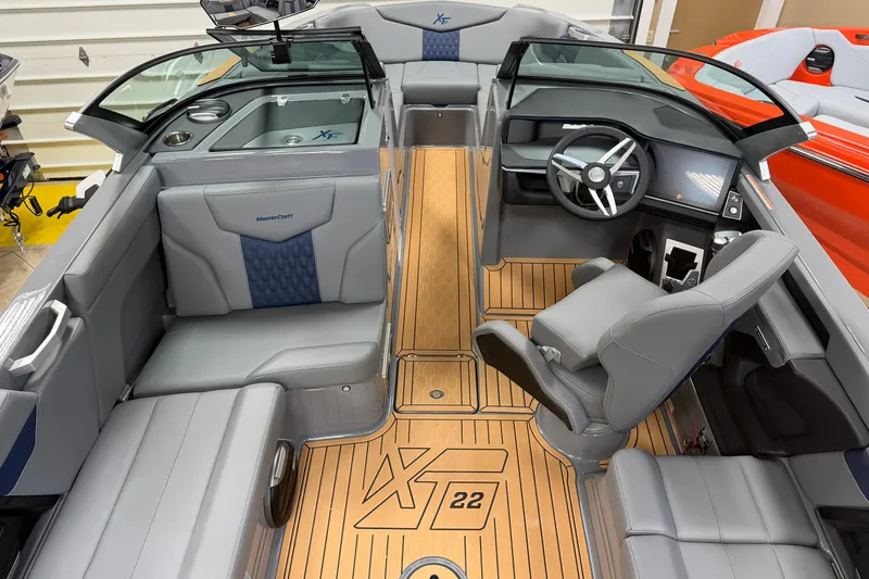 Slide: The Image of 2026 MasterCraft XT22 boat interior with sleek seating and modern dashboard design. - 5