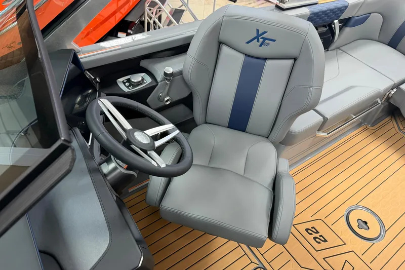 Slide: The Image of 2026 MasterCraft XT22 boat interior with steering wheel and captain's seat. - 6
