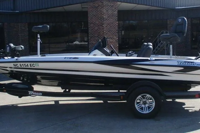 The Image of 2016 Triton 179 TrX boat on trailer, parked outside a brick building. - 1
