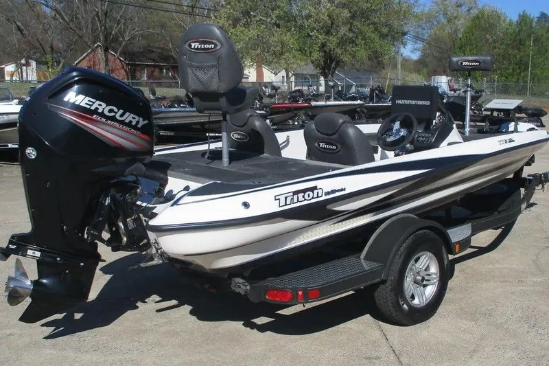 Slide: The Image of 2016 Triton 179 TrX boat with Mercury engine on trailer, parked outdoors. - 3