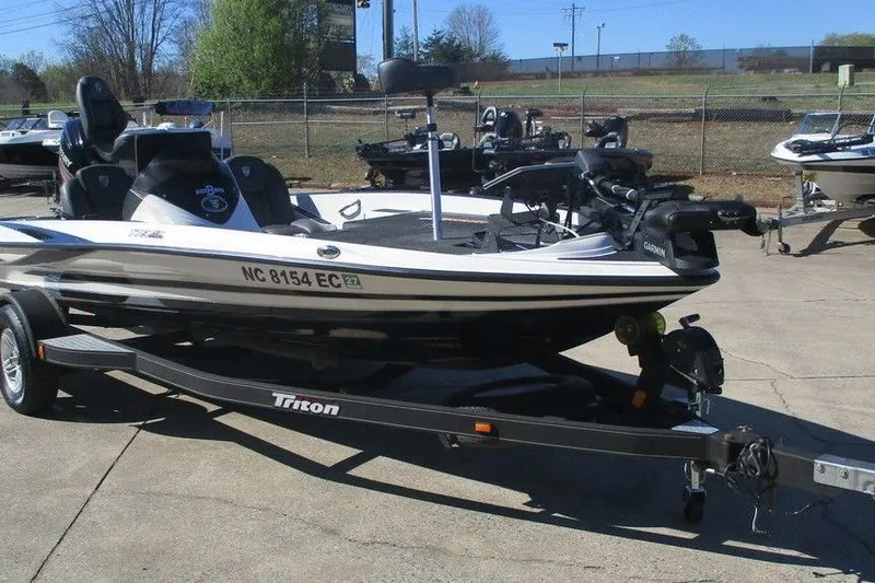 Slide: The Image of 2016 Triton 179 TrX boat on trailer in outdoor setting. - 4