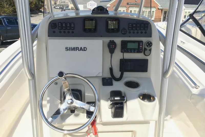 Slide: The Image of 2014 Pioneer 222 Sportfish boat console with steering wheel and Simrad electronics. - 4