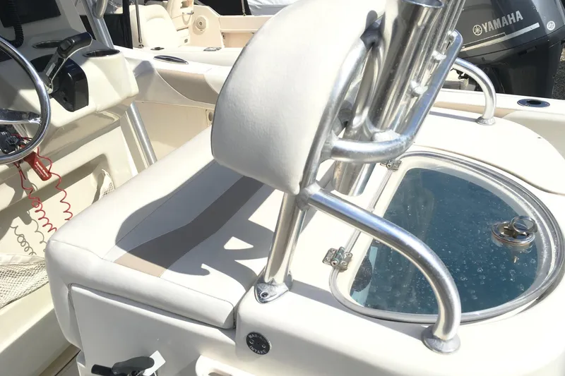 Slide: The Image of 2014 Pioneer 222 Sportfish boat interior with steering wheel and livewell. - 7
