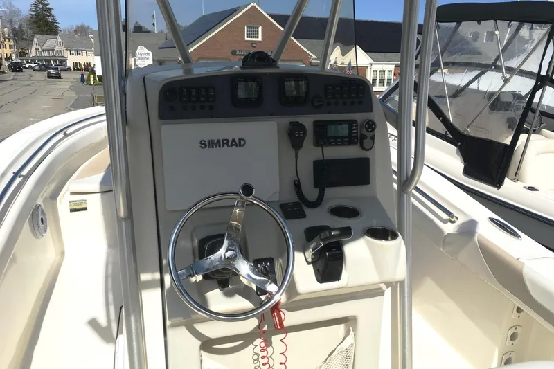 Slide: The Image of 2014 Pioneer 222 Sportfish boat console with Simrad electronics and steering wheel. - 9