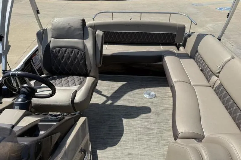 Slide: The Image of 2020 Bennington 25 QSBIO boat interior with luxurious seating and steering wheel. - 11