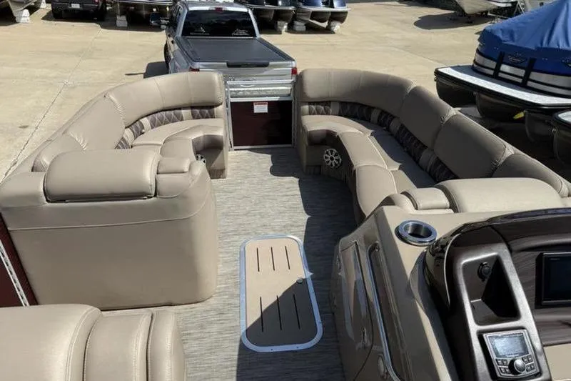 Slide: The Image of 2020 Bennington 25 QSBIO pontoon boat interior with plush seating and modern dashboard. - 17