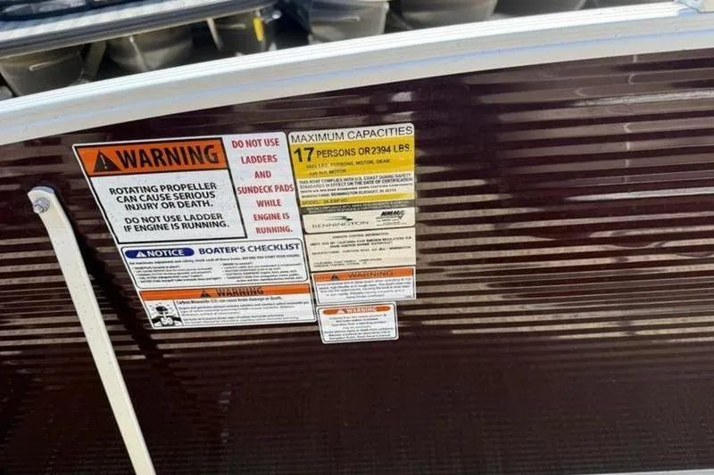Slide: The Image of Warning and capacity labels on 2020 Bennington 25 QSBIO boat, maximum 17 persons or 2394 lbs. - 20